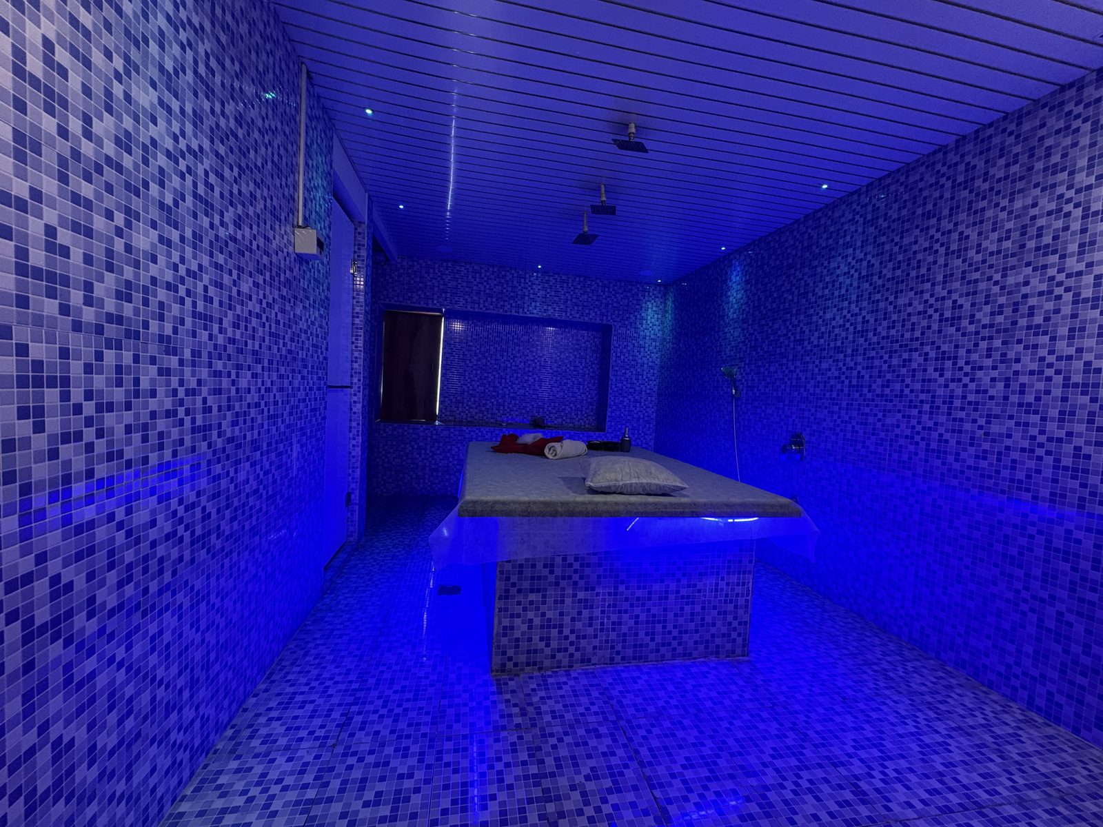 Steam room with a central treatment table